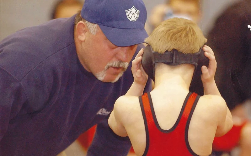 Joe Rigous coaching young wrestler